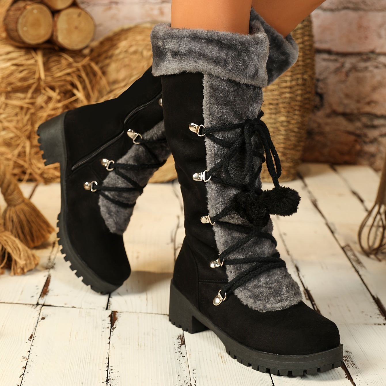 Women's black winter boots with plush trim, laces, and a zipper