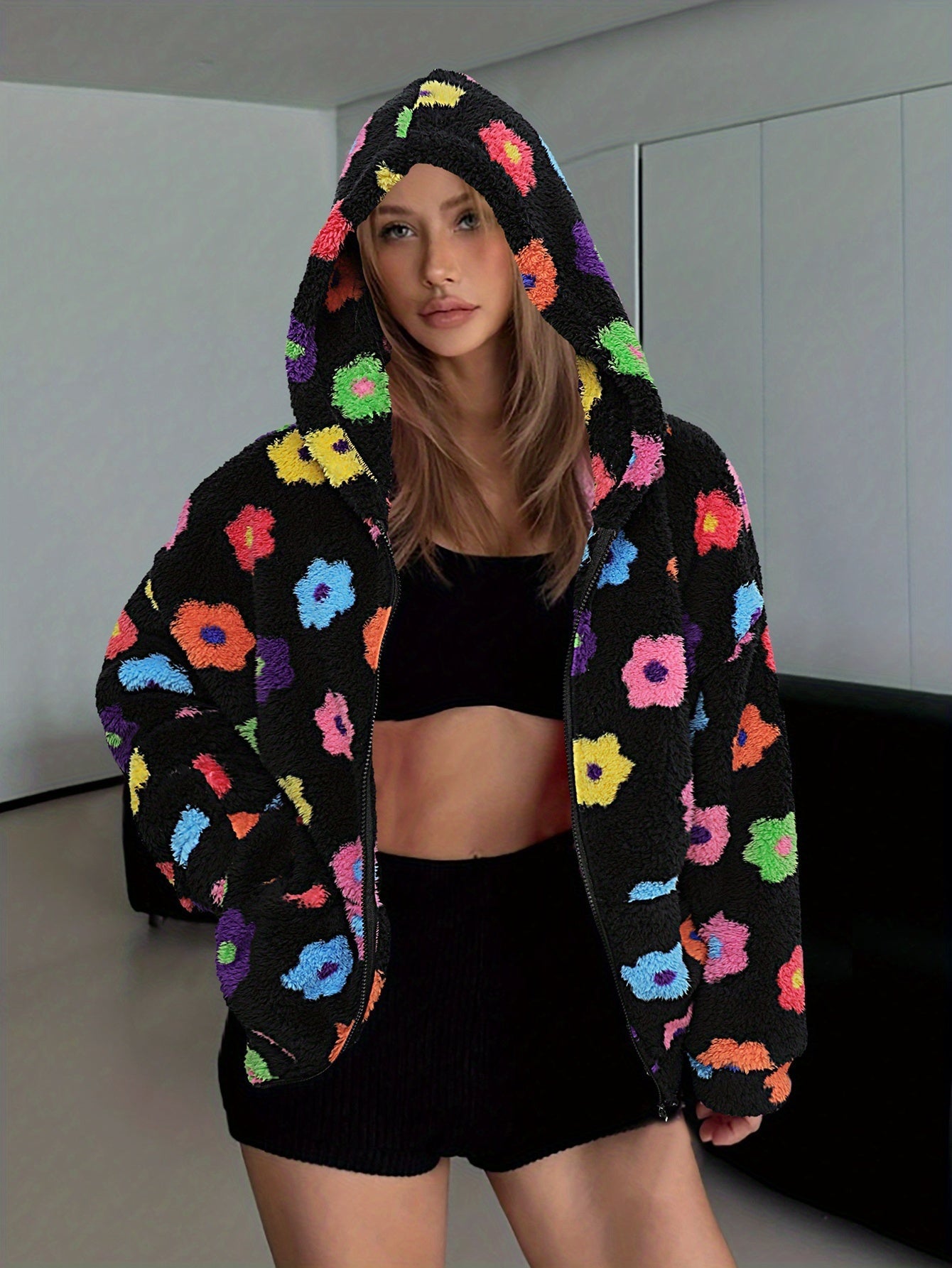 Hooded teddy jacket with colorful floral patterns and a zipper