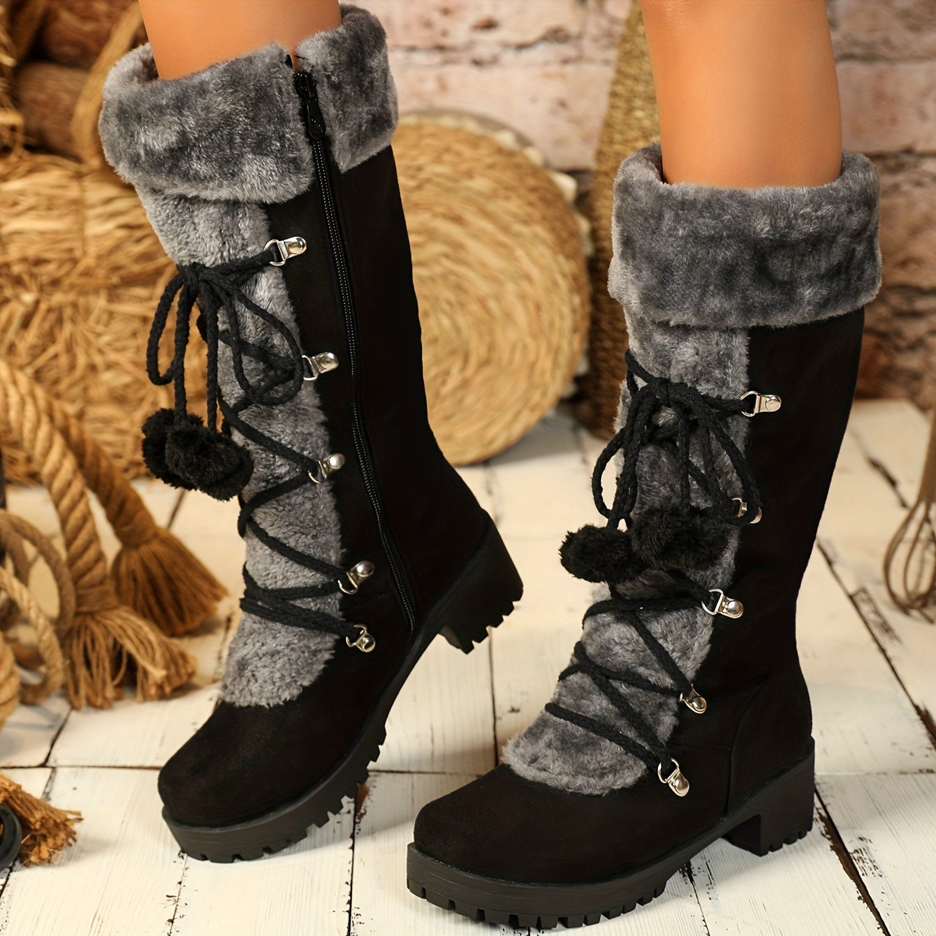 Women's black winter boots with plush trim, laces, and a zipper