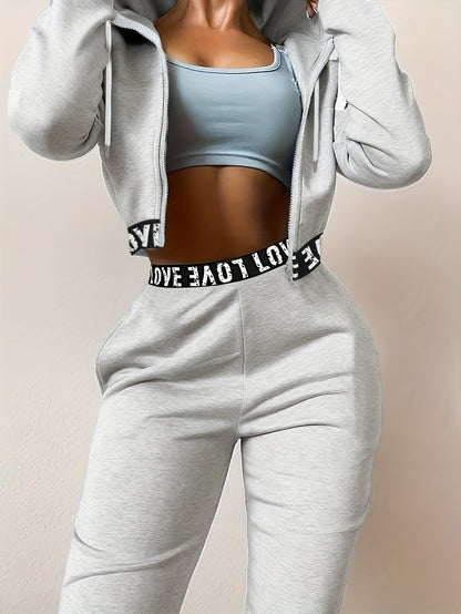 Women's two-piece tracksuit with a hooded jacket and cropped-length joggers featuring a “LOVE” waistband
