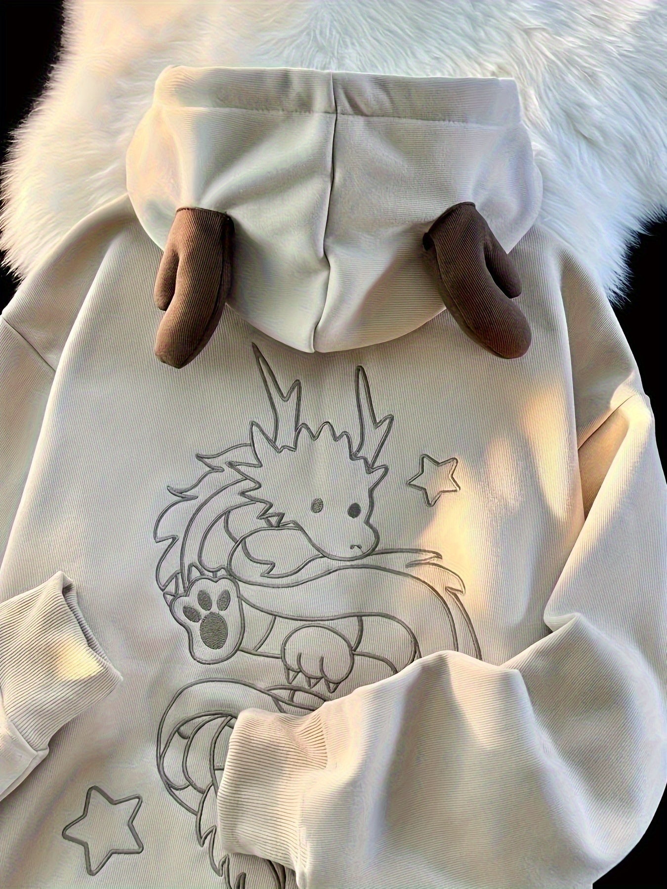 Beige zip-up hoodie with dragon embroidery and antler hood