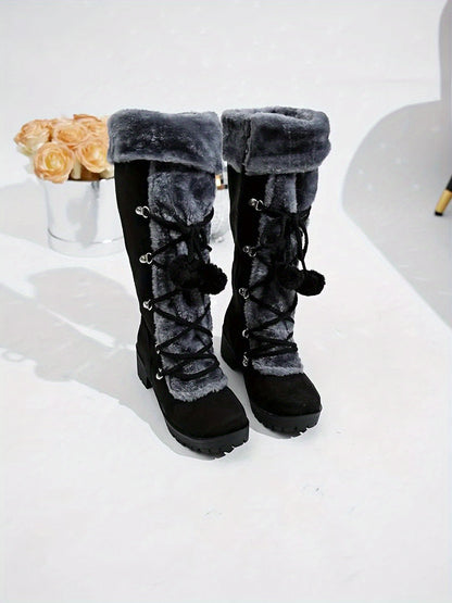 Women's black winter boots with plush trim, laces, and a zipper