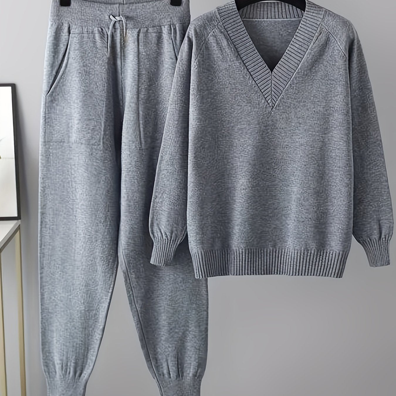 Two-piece women’s knitted set with a V-neck sweater and jogger pants in a beige ribbed-knit design