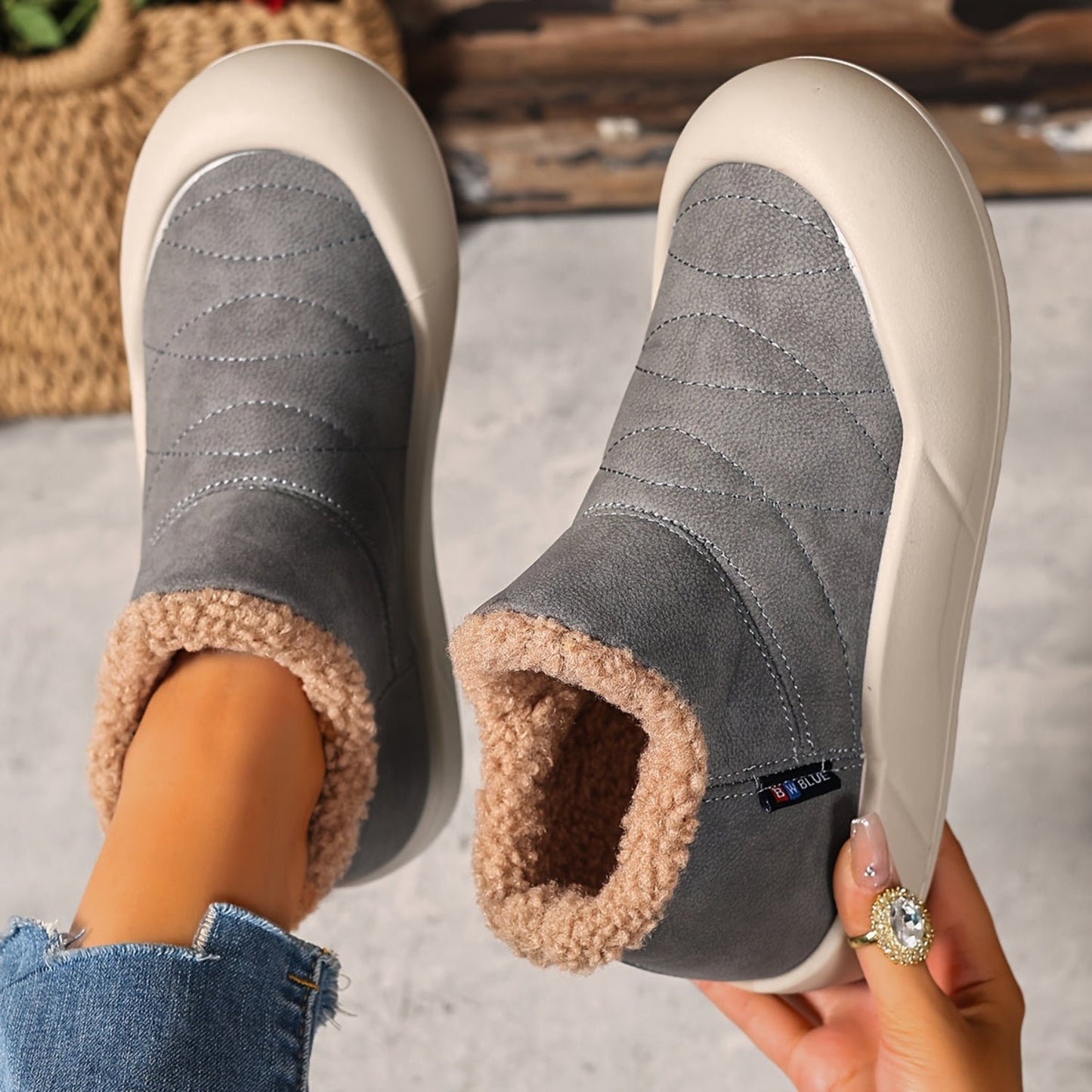 Lined gray ankle boots with quilted uppers and beige plush lining