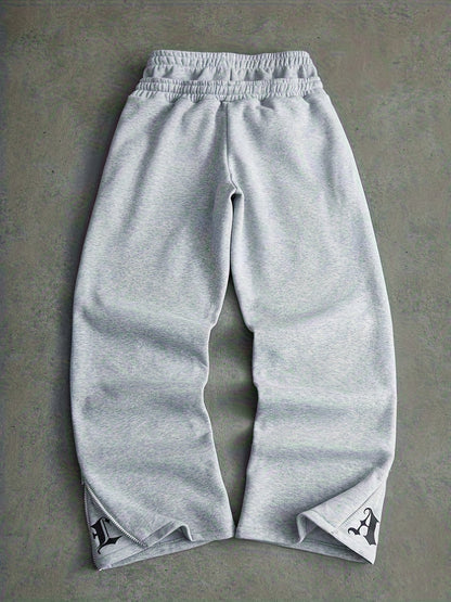 Loose-fit men's joggers with embroidered lettering on the legs, drawstring waistband, black