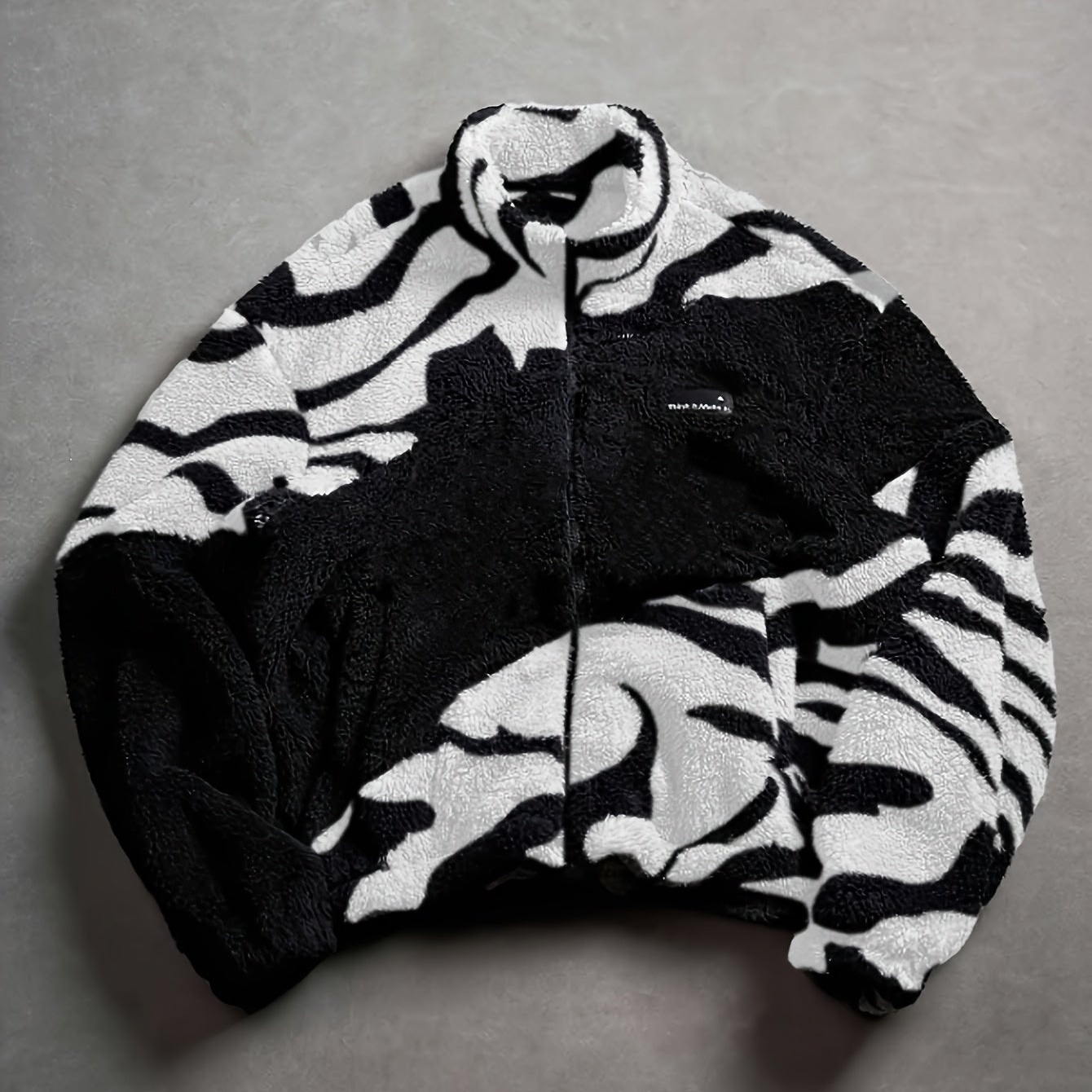 Unisex fleece jacket with stand-up collar, zipper, and animal print