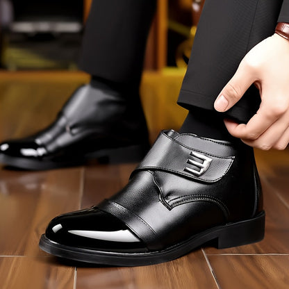 Black men’s slip-on ankle boots with a polished toe cap and Velcro fastening