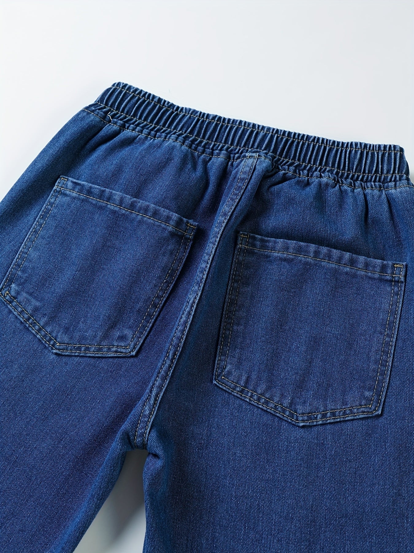 Dark blue jeans with an elastic waistband and drawstring