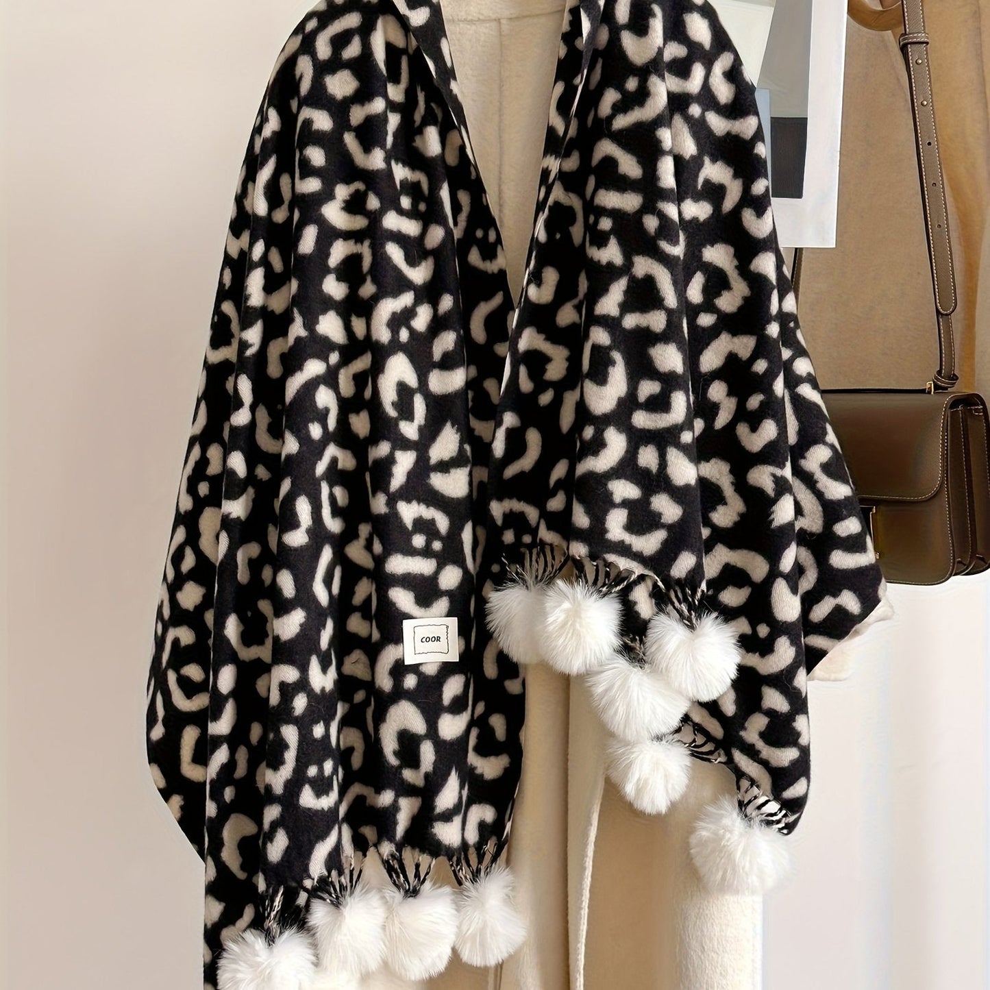 Leopard-print scarf with pom-poms