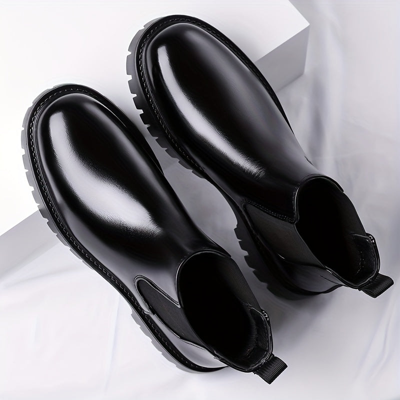 Black Chelsea boots with elastic panels and a lug sole