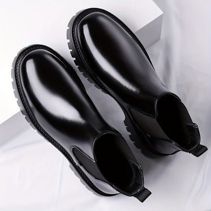 Black Chelsea boots with elastic panels and a lug sole