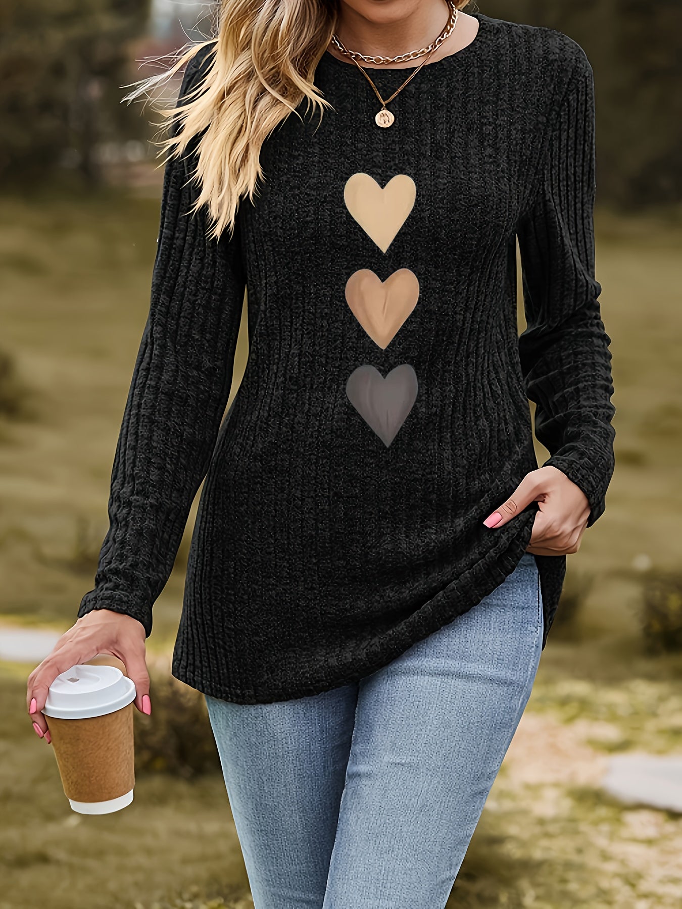Women's black long-sleeve shirt with heart appliqués