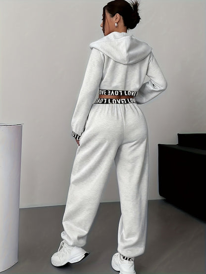 Women's two-piece tracksuit with a hooded jacket and cropped-length joggers featuring a “LOVE” waistband