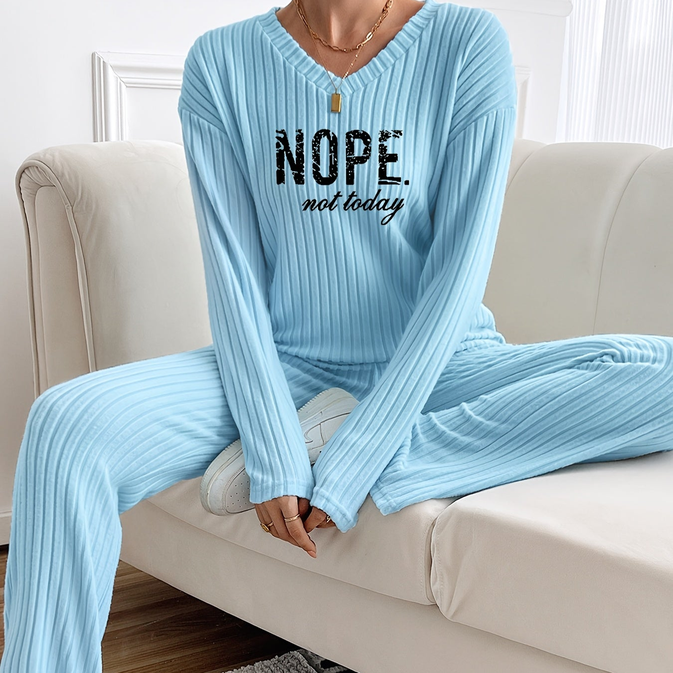 Ribbed women’s two-piece set with a V-neck top featuring lettering and wide-leg pants