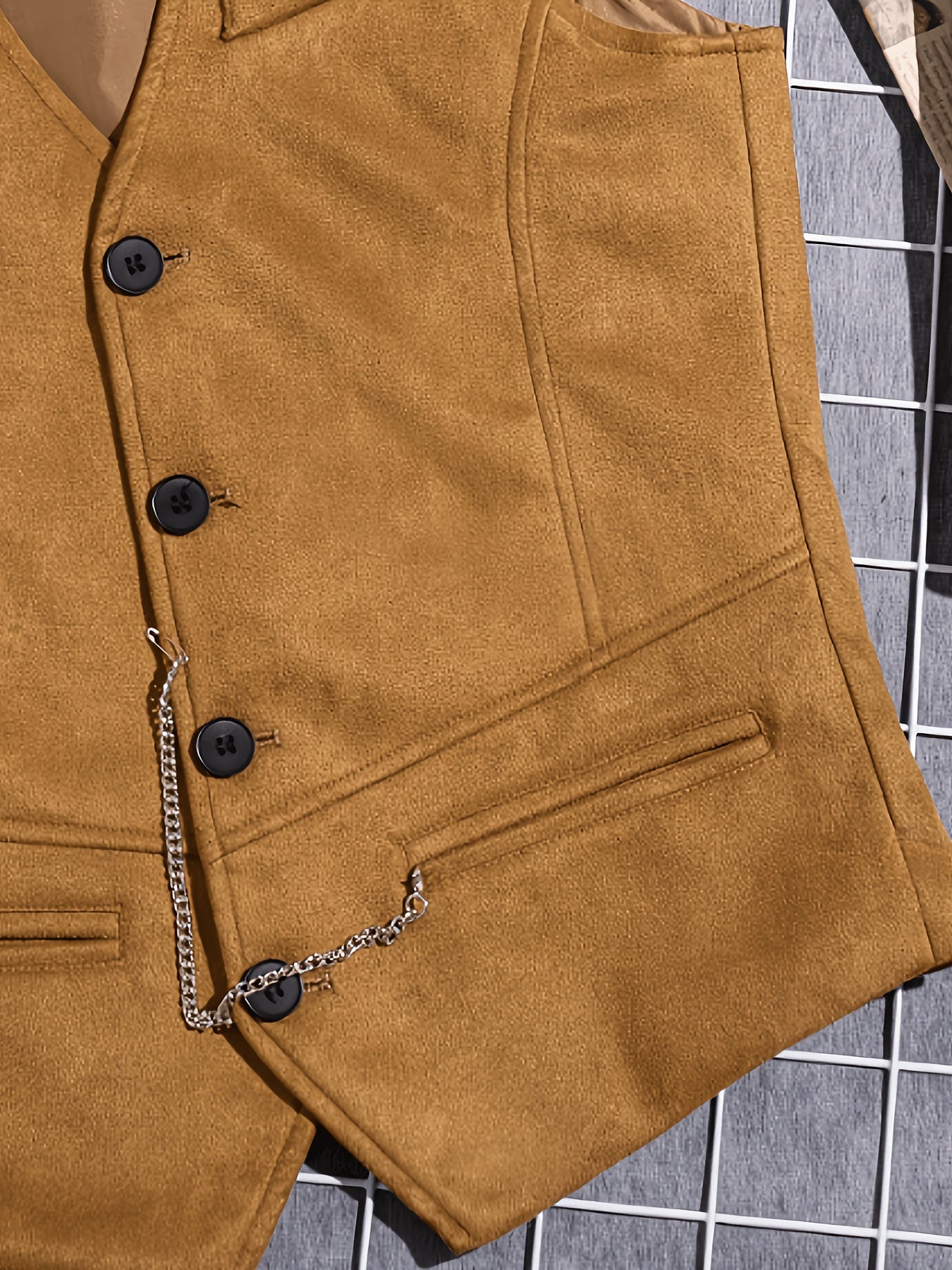 Men's vest with V-neck, button placket, and chain detail