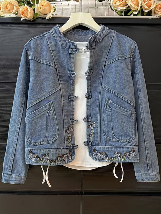 Women's denim jacket with stand-up collar, frog closures, and embroidery