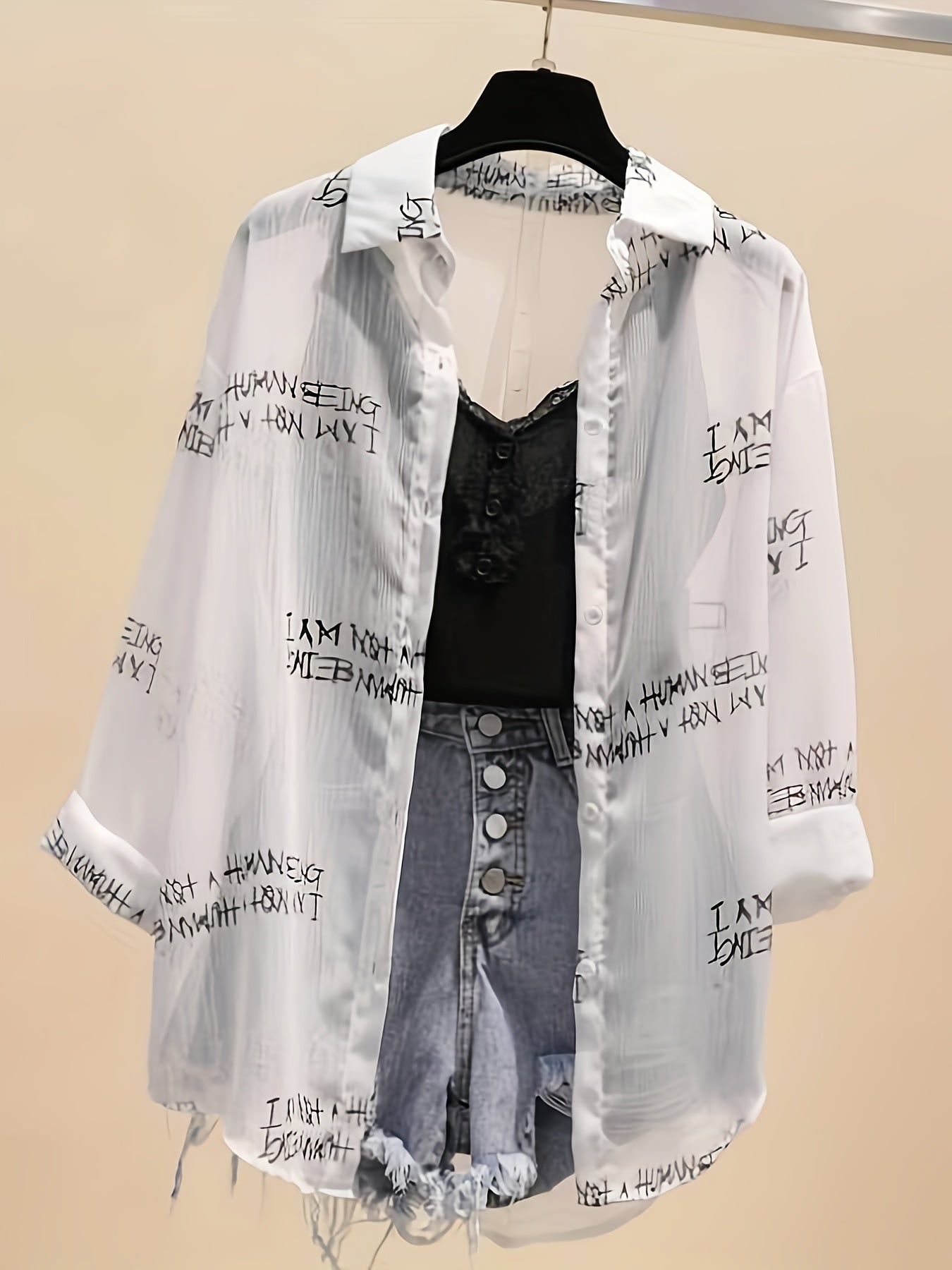 Women's blouse with newspaper print and shorts – fashionable set for leisure and everyday wear