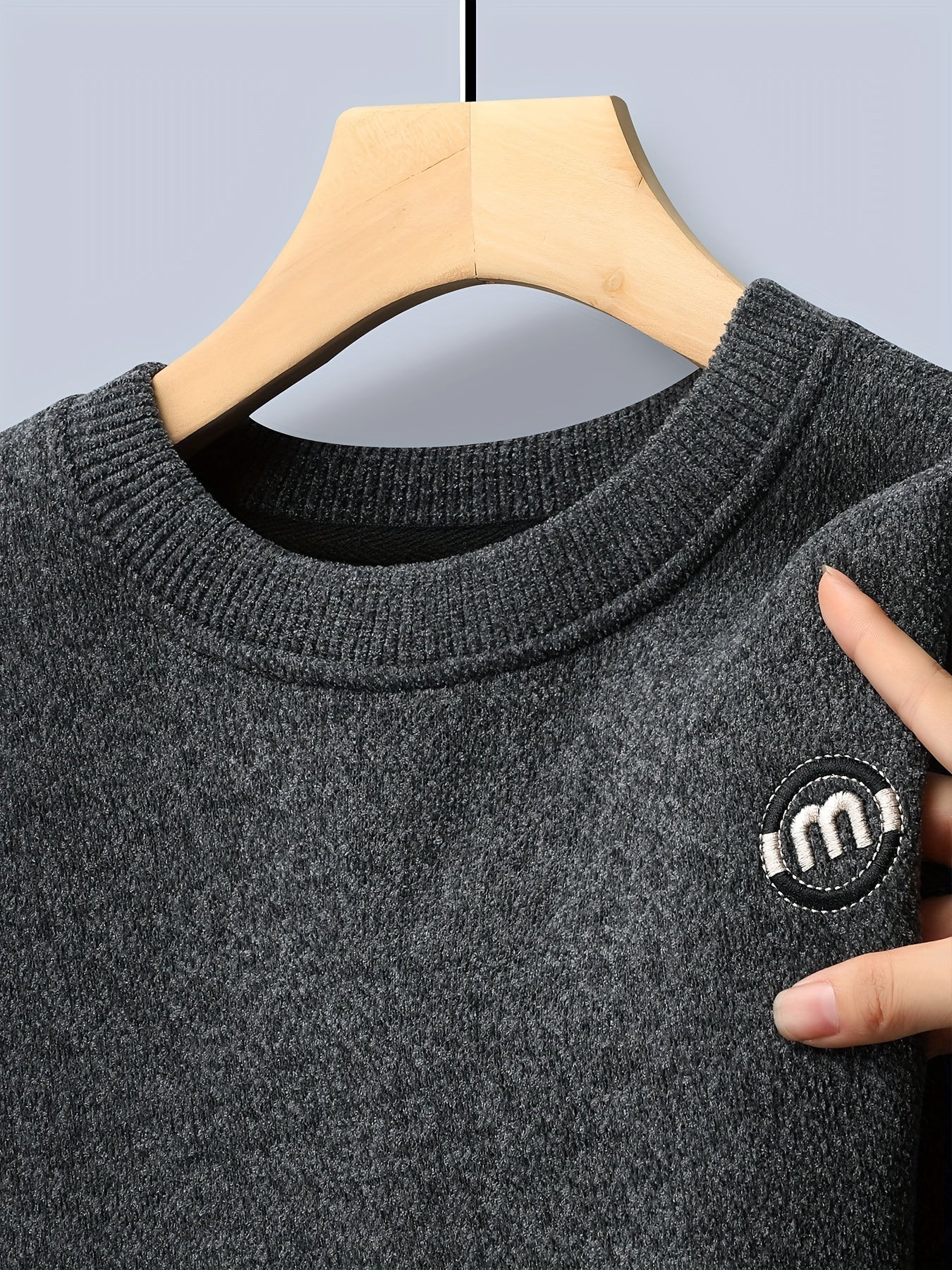 Unisex long-sleeve pullover with a crew neck and ribbed cuffs, lined