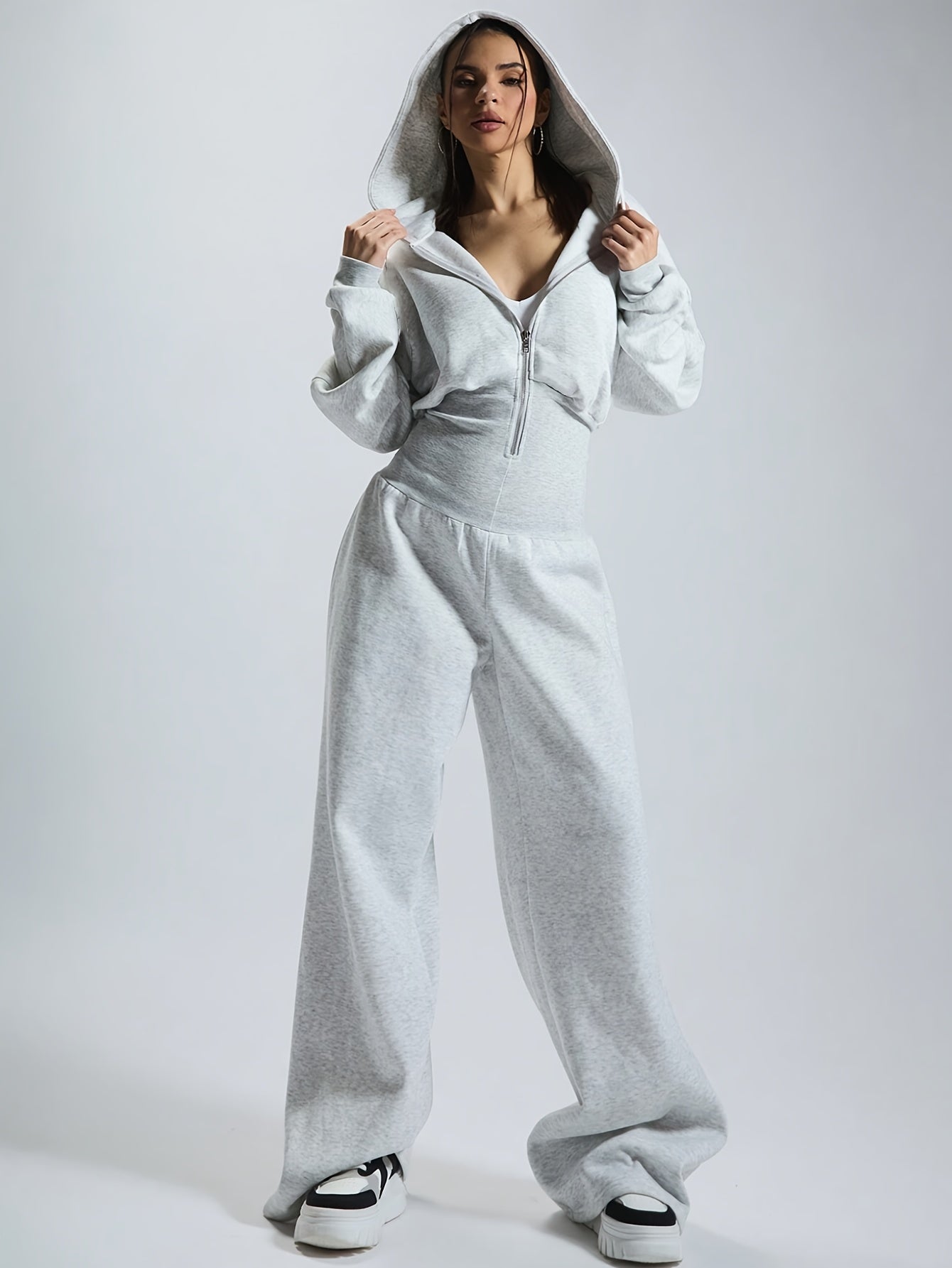 Women's jumpsuit with hood, long sleeves, wide legs, and zipper