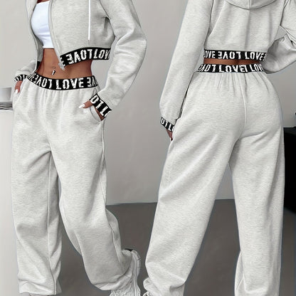 Women's two-piece tracksuit with a hooded jacket and cropped-length joggers featuring a “LOVE” waistband