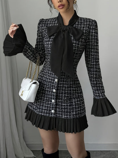 Black-and-white checked dress with a bow and pleated details